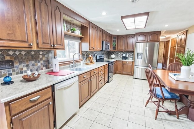 37 Colonial Way, Rehoboth, MA 02769 - kitchen with stainless steel appliances, light tile patterned floors, open shelves, tasteful backsplash, and light countertops