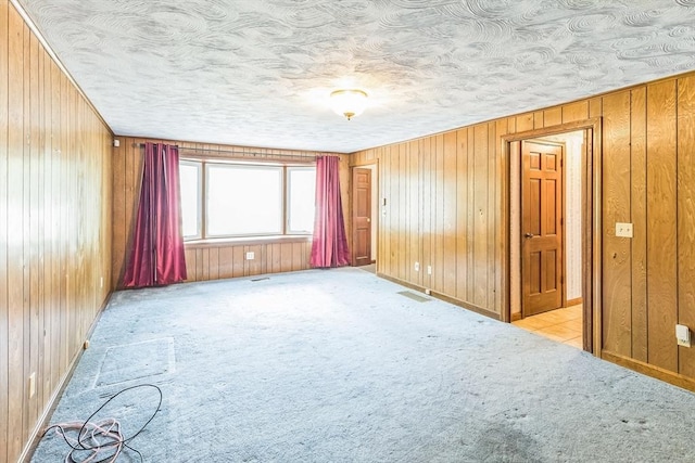 37 Colonial Way, Rehoboth, MA 02769 - unfurnished room with wood walls and light carpet