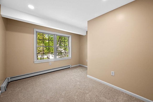 carpeted empty room with a baseboard radiator, baseboards, and recessed lighting
