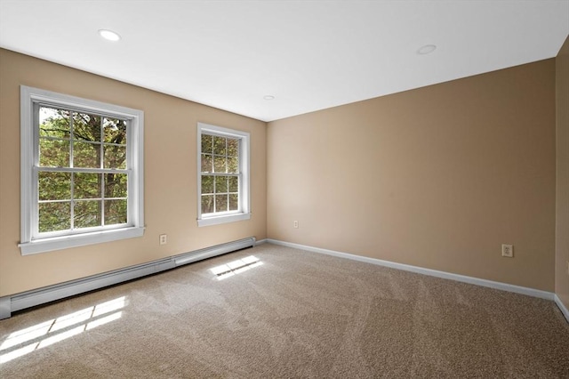 empty room with baseboard heating, carpet, baseboards, and recessed lighting