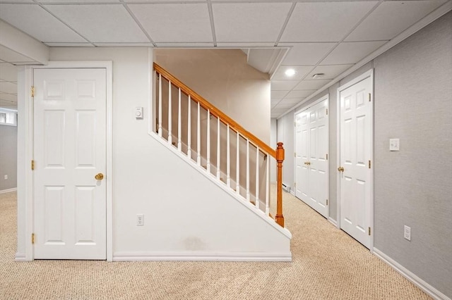 stairway with a paneled ceiling, carpet, recessed lighting, and baseboards