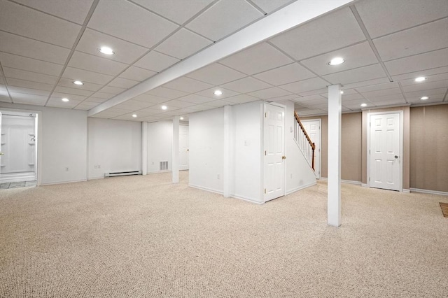 finished below grade area featuring recessed lighting, light colored carpet, a baseboard radiator, stairs, and a drop ceiling
