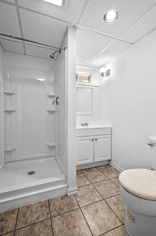 full bath featuring a shower stall, tile patterned flooring, toilet, and vanity