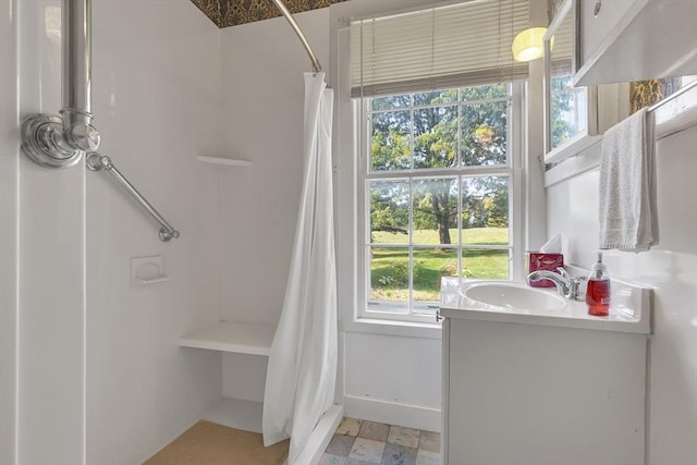 bathroom featuring vanity and a shower with shower curtain