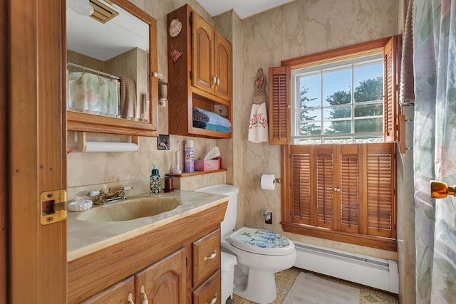 bathroom featuring vanity, a baseboard heating unit, and toilet