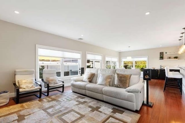 living room with wood finished floors and recessed lighting