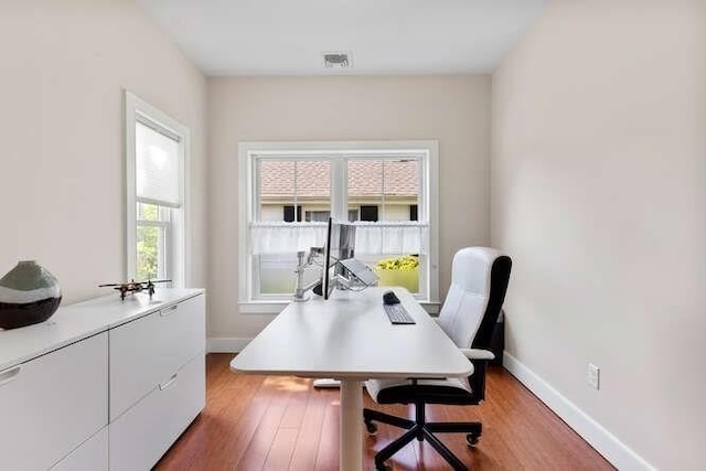 office space with light wood-style floors and baseboards