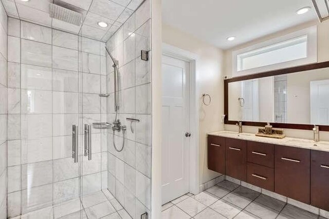 full bathroom with a shower stall, double vanity, tile patterned floors, and recessed lighting