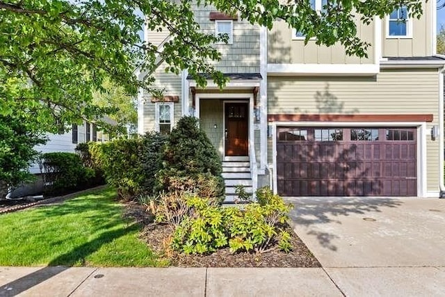 townhome / multi-family property with an attached garage, concrete driveway, and board and batten siding
