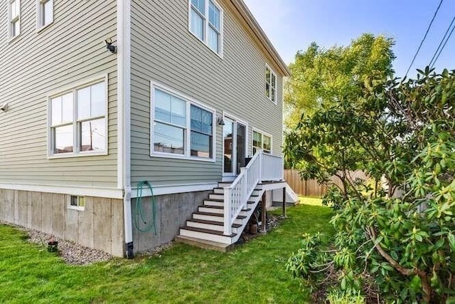 view of side of property with stairway and crawl space