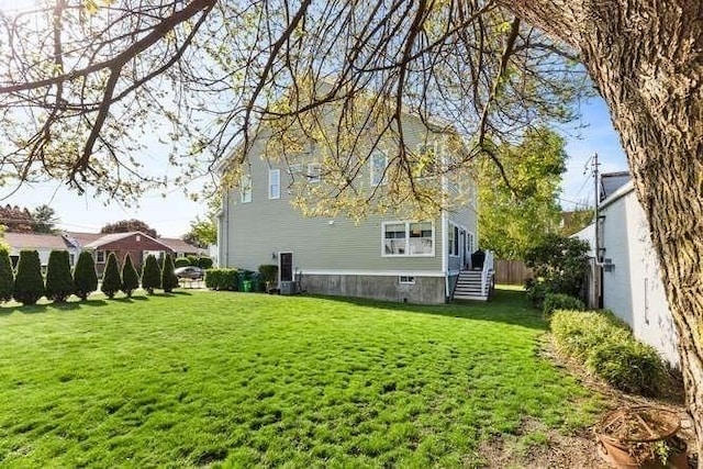 back of property featuring a lawn