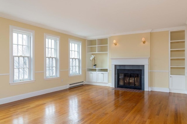unfurnished living room featuring built in shelves, wood finished floors, baseboards, a tiled fireplace, and baseboard heating