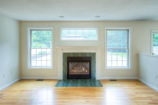 interior details with hardwood / wood-style flooring and a high end fireplace