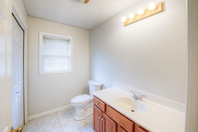 bathroom with vanity, tile patterned floors, and toilet