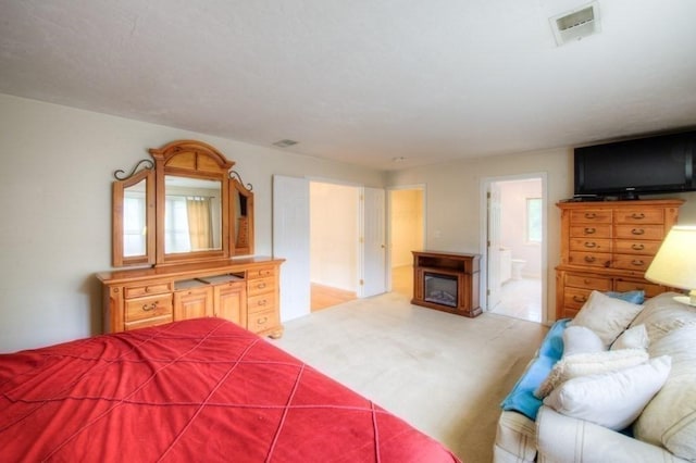 carpeted bedroom with ensuite bath