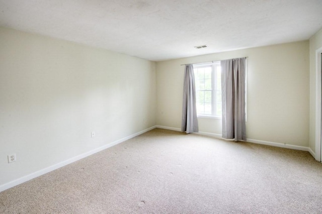 empty room with light colored carpet