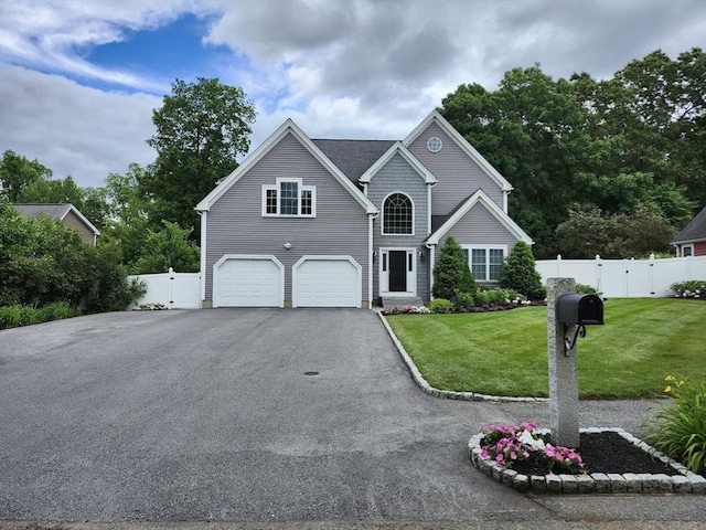 view of front of property with a garage and a front lawn