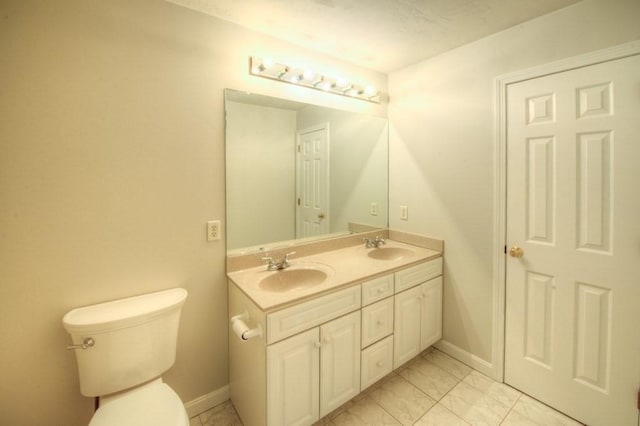 bathroom featuring vanity and toilet