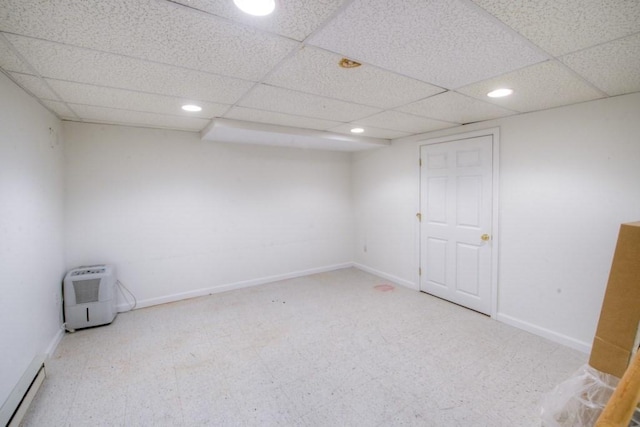 spare room with a baseboard radiator and a drop ceiling