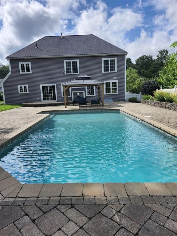 view of pool with an outdoor structure and a patio