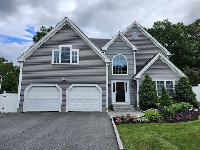 view of front of house featuring a garage and a front yard