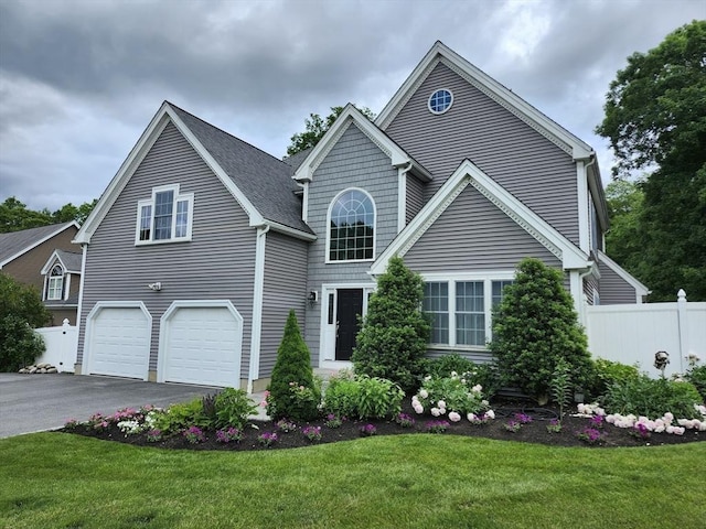 view of front of property featuring a garage and a front lawn