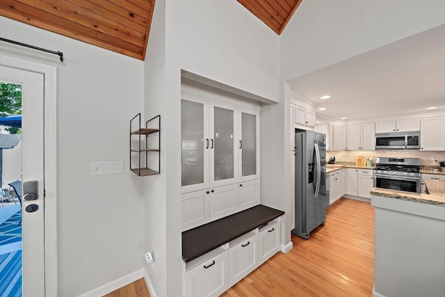 10 Stoughton Rd, Dedham, MA 02026 - mudroom with light wood-style floors, vaulted ceiling, recessed lighting, and baseboards