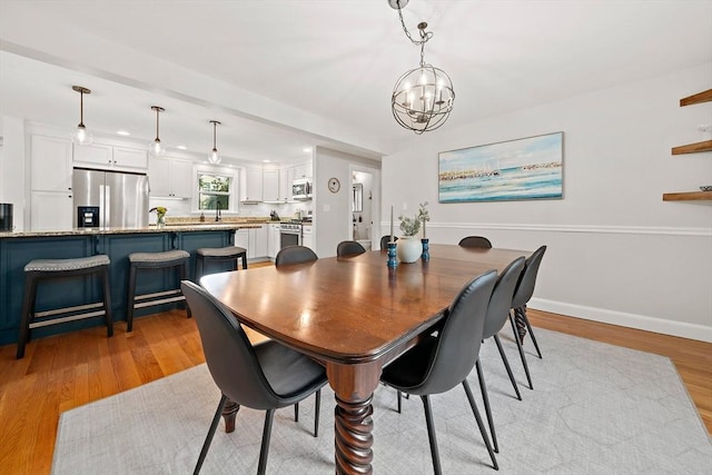 10 Stoughton Rd, Dedham, MA 02026 - dining space featuring a chandelier, light wood-type flooring, and baseboards
