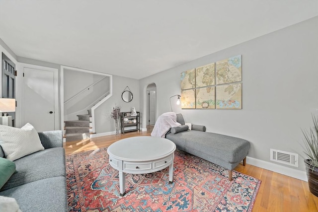10 Stoughton Rd, Dedham, MA 02026 - living area featuring arched walkways, stairs, baseboards, and wood finished floors