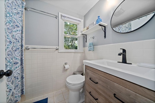 10 Stoughton Rd, Dedham, MA 02026 - bathroom featuring tile walls, tile patterned flooring, toilet, wainscoting, and vanity