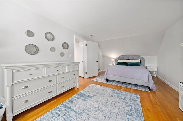 10 Stoughton Rd, Dedham, MA 02026 - bedroom with lofted ceiling, light wood finished floors, and baseboards