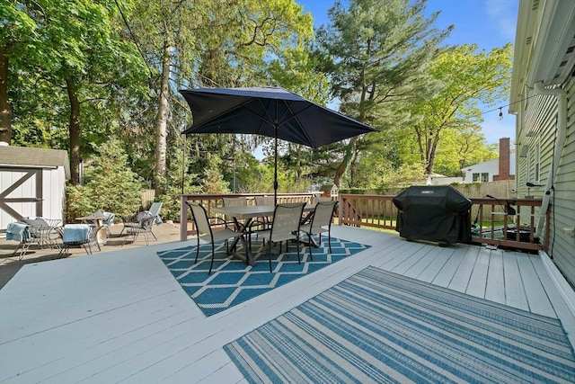 10 Stoughton Rd, Dedham, MA 02026 - wooden terrace with outdoor dining space, a grill, and view of wooded area