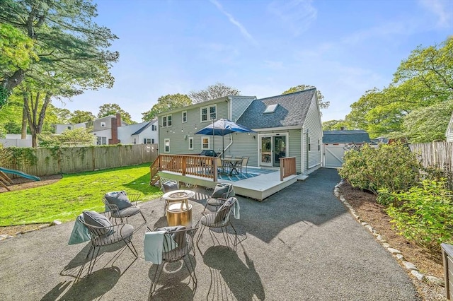 10 Stoughton Rd, Dedham, MA 02026 - rear view of property featuring a deck, a shingled roof, outdoor dining space, and a patio