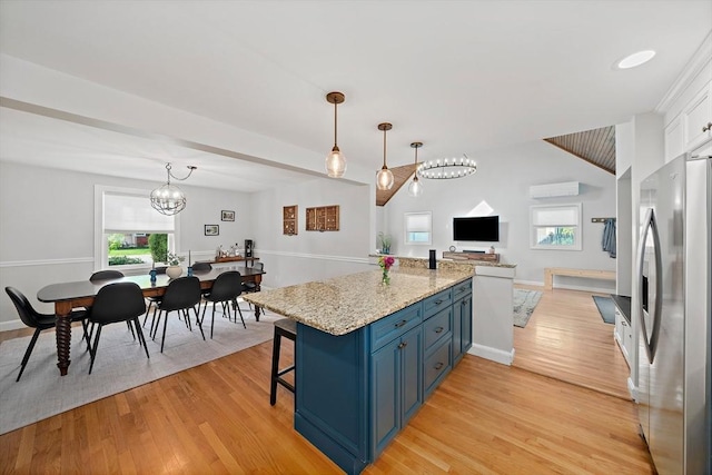 10 Stoughton Rd, Dedham, MA 02026 - kitchen featuring freestanding refrigerator, blue cabinetry, healthy amount of natural light, and open floor plan