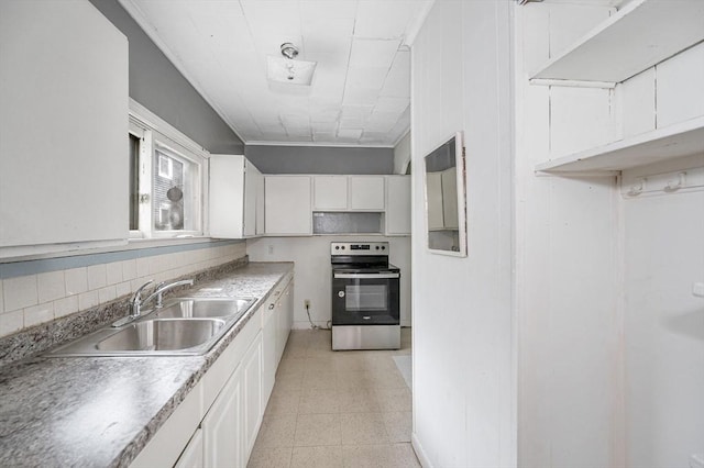 34 May St, Lowell, MA 01850 - kitchen with stainless steel electric range, light flooring, white cabinetry, light countertops, and decorative backsplash