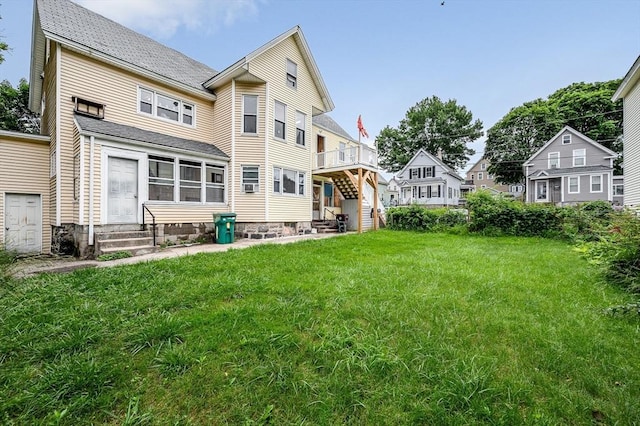 34 May St, Lowell, MA 01850 - rear view of house featuring entry steps, a lawn, and a residential view
