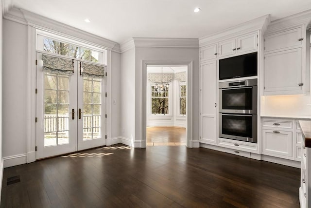 entryway featuring french doors, visible vents, crown molding, baseboards, and dark wood-style floors
