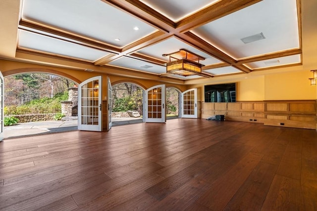 interior space with a wainscoted wall, french doors, hardwood / wood-style flooring, and coffered ceiling