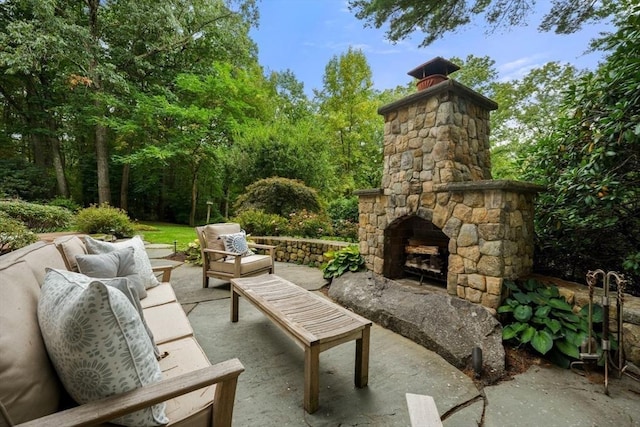view of patio / terrace with an outdoor living space with a fireplace