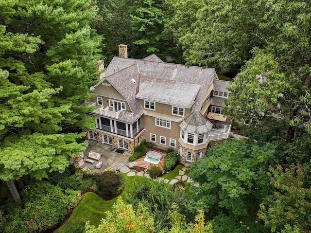 bird's eye view with a wooded view