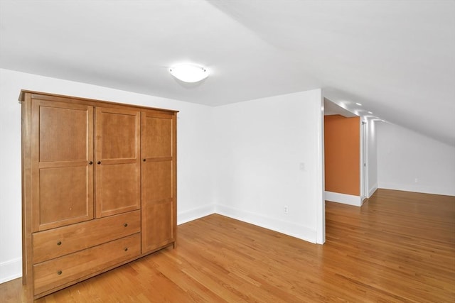 49 Norfolk St, Boston, MA 02119 - unfurnished bedroom featuring baseboards, vaulted ceiling, and light wood-type flooring