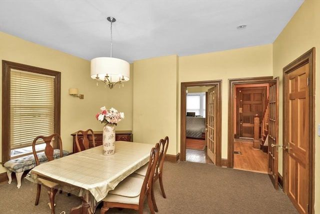 49 Norfolk St, Boston, MA 02119 - dining space featuring baseboards, carpet, and a notable chandelier