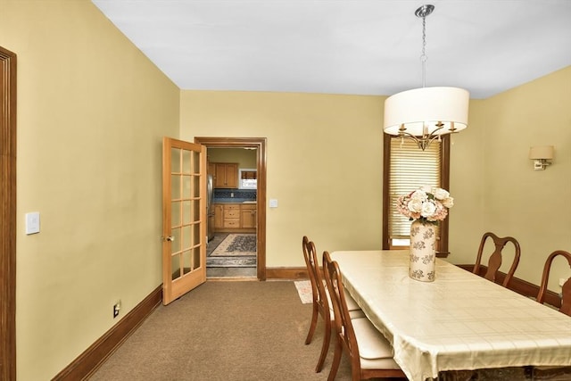 49 Norfolk St, Boston, MA 02119 - carpeted dining space with baseboards and a notable chandelier