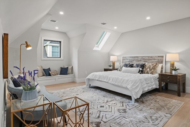 bedroom with a skylight, light wood-type flooring, lofted ceiling, baseboards, and recessed lighting