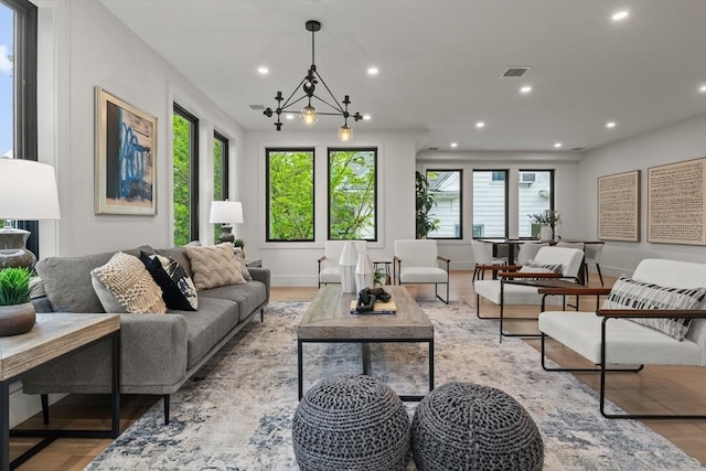 living area featuring recessed lighting, wood finished floors, and baseboards