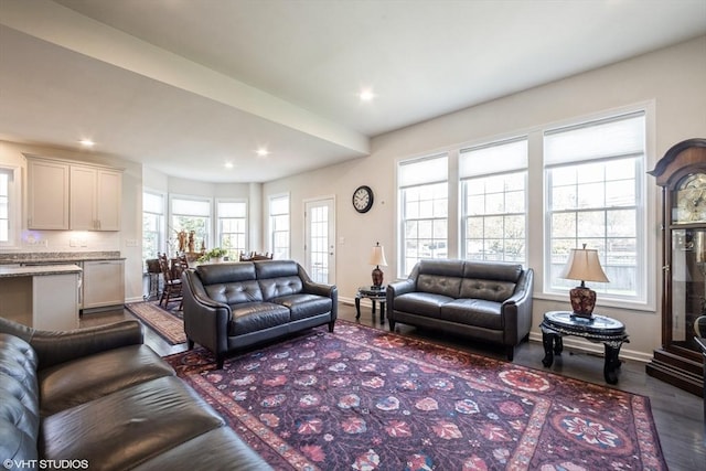 living area with recessed lighting, baseboards, and dark wood-style floors