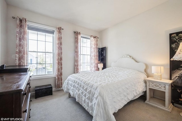 carpeted bedroom with baseboards