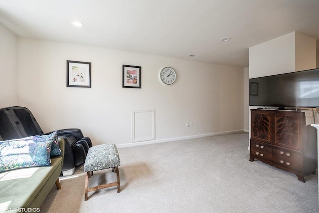 sitting room with light colored carpet, recessed lighting, and baseboards