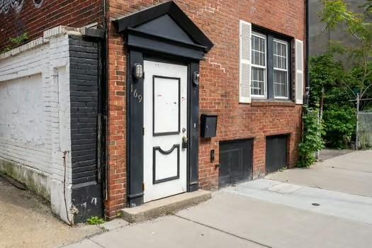 145-169 N Washington St, Boston, MA 02114 - property entrance with brick siding and an attached garage