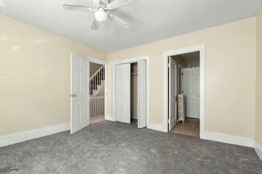 145-169 N Washington St, Boston, MA 02114 - unfurnished bedroom with radiator, carpet, a closet, and baseboards